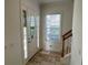 Bright entryway with tile flooring and staircase at 7465 Excitement Dr, Reunion, FL 34747