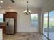 Bright dining area with tile floors and access to a patio at 7465 Excitement Dr, Reunion, FL 34747