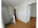 A bright hallway with hardwood floors, leading to bedrooms and stairs at 7465 Excitement Dr, Reunion, FL 34747