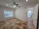 Spacious living room with tile floors and a view of the staircase at 7465 Excitement Dr, Reunion, FL 34747