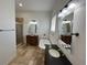 Bathroom with soaking tub, walk-in shower, and dark vanity at 7465 Excitement Dr, Reunion, FL 34747