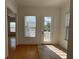 Bright sunroom with hardwood floors, French doors, and window blinds at 7465 Excitement Dr, Reunion, FL 34747