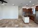 Open kitchen with island, stainless steel appliances, and wood cabinets at 7465 Excitement Dr, Reunion, FL 34747
