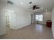 Spacious bonus room with tile flooring, ceiling fan and adjacent bathroom at 7465 Excitement Dr, Reunion, FL 34747