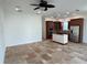 Open kitchen with island, stainless steel appliances, and wood cabinets at 7465 Excitement Dr, Reunion, FL 34747