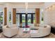 Living room with curved sectional sofa and pool view at 256 New Gate Loop, Lake Mary, FL 32746