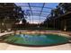 Inviting screened pool with spa and tranquil backyard views at dusk at 256 New Gate Loop, Lake Mary, FL 32746