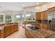 Kitchen with granite island, stainless steel appliances, and backyard view at 256 New Gate Loop, Lake Mary, FL 32746
