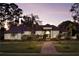 Elegant home with brick pavers and landscaping at dusk at 256 New Gate Loop, Lake Mary, FL 32746