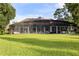 Back of house, showcasing a large covered patio and lush lawn at 256 New Gate Loop, Lake Mary, FL 32746