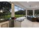 Outdoor kitchen, seating area, and pool view from covered patio at 256 New Gate Loop, Lake Mary, FL 32746