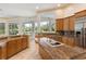 Kitchen with granite island, stainless steel appliances, and backyard view at 256 New Gate Loop, Lake Mary, FL 32746
