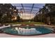 Expansive pool and spa with screened enclosure and sunset view at 256 New Gate Loop, Lake Mary, FL 32746