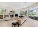 Bright living room with a fireplace, large windows, and comfortable seating at 256 New Gate Loop, Lake Mary, FL 32746