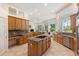 Large kitchen with island, granite counters, and wood cabinets at 256 New Gate Loop, Lake Mary, FL 32746