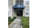 Building entrance with stairs and landscaping at 3000 Laurel Park Ln # 104, Kissimmee, FL 34741