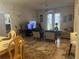 Spacious living room with tiled floors, comfy seating, and access to a patio at 3000 Laurel Park Ln # 104, Kissimmee, FL 34741