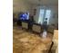 Spacious living room with tiled floors, comfy seating, and access to a patio at 3000 Laurel Park Ln # 104, Kissimmee, FL 34741