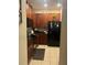 Kitchen with dark wood cabinets and black appliances at 3000 Laurel Park Ln # 104, Kissimmee, FL 34741