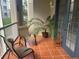 Relaxing screened balcony with patio furniture and potted plants at 3000 Laurel Park Ln # 104, Kissimmee, FL 34741