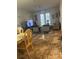 Spacious living room with tiled floors, comfy seating, and access to a patio at 3000 Laurel Park Ln # 104, Kissimmee, FL 34741