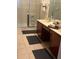 Double vanity bathroom with a large walk-in shower at 3000 Laurel Park Ln # 104, Kissimmee, FL 34741
