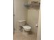 Simple bathroom with toilet, storage shelves, and tiled floor at 3000 Laurel Park Ln # 104, Kissimmee, FL 34741