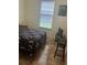 Bedroom with tile flooring, window, and TV stand at 3000 Laurel Park Ln # 104, Kissimmee, FL 34741
