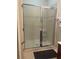 Shower with glass enclosure and tiled walls at 3000 Laurel Park Ln # 104, Kissimmee, FL 34741