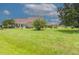 Landscaped front yard with spacious lawn and mature trees at 2228 Sylvan Ct, Kissimmee, FL 34746