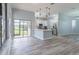 Open concept kitchen with breakfast bar and view to backyard at 2228 Sylvan Ct, Kissimmee, FL 34746