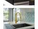 Modern kitchen sink and faucet with designer backsplash at 2228 Sylvan Ct, Kissimmee, FL 34746
