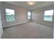 Bedroom with neutral walls, carpet, and multiple windows at 7924 Spectrum Dr, Kissimmee, FL 34747