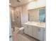 Modern bathroom with double vanity, shower, and tile flooring at 7924 Spectrum Dr, Kissimmee, FL 34747
