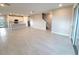 Open living area with tile floors and views to the kitchen and staircase at 7924 Spectrum Dr, Kissimmee, FL 34747
