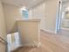 Upstairs hallway with wood-look laminate floors and access to bedrooms and bathroom at 7924 Spectrum Dr, Kissimmee, FL 34747