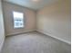 Bright bedroom with neutral walls and carpet at 7924 Spectrum Dr, Kissimmee, FL 34747