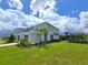 Modern townhome with gray siding, landscaping, and a spacious yard at 7924 Spectrum Dr, Kissimmee, FL 34747