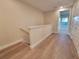 Upstairs hallway with wood-look laminate flooring and multiple doors at 7924 Spectrum Dr, Kissimmee, FL 34747