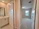 Clean bathroom with a vanity and access to other rooms at 7924 Spectrum Dr, Kissimmee, FL 34747