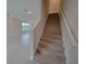 Modern staircase with wood-look laminate treads and white railing at 7924 Spectrum Dr, Kissimmee, FL 34747