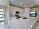 Modern kitchen with white cabinets, quartz countertops and stainless steel appliances at 7924 Spectrum Dr, Kissimmee, FL 34747