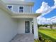 Front entryway with modern blue door and stone patio at 7924 Spectrum Dr, Kissimmee, FL 34747