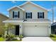 Two-story home with neutral siding and two-car garage at 4469 Sagefield Dr, St Cloud, FL 34773