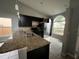 Kitchen boasts granite countertops and dark cabinetry at 1928 Larkwood Dr, Apopka, FL 32703