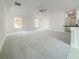 Large living room with grey carpet, ceiling fan, and multiple windows at 4197 Sagefield Dr, Harmony, FL 34773