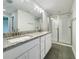 Bathroom with double vanity, granite countertop, and a large glass shower at 4197 Sagefield Dr, Harmony, FL 34773