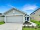 Attractive single-story house with a two-car garage and landscaped walkway at 4197 Sagefield Dr, Harmony, FL 34773