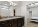 Double vanity bathroom with granite countertop and dark wood cabinets at 8869 Rhodes St, Kissimmee, FL 34747