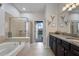 Spa-like bathroom with soaking tub, walk-in shower, and dual vanity at 8869 Rhodes St, Kissimmee, FL 34747
